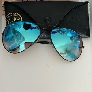 black ray-ban aviators with blue lenses. original size.
